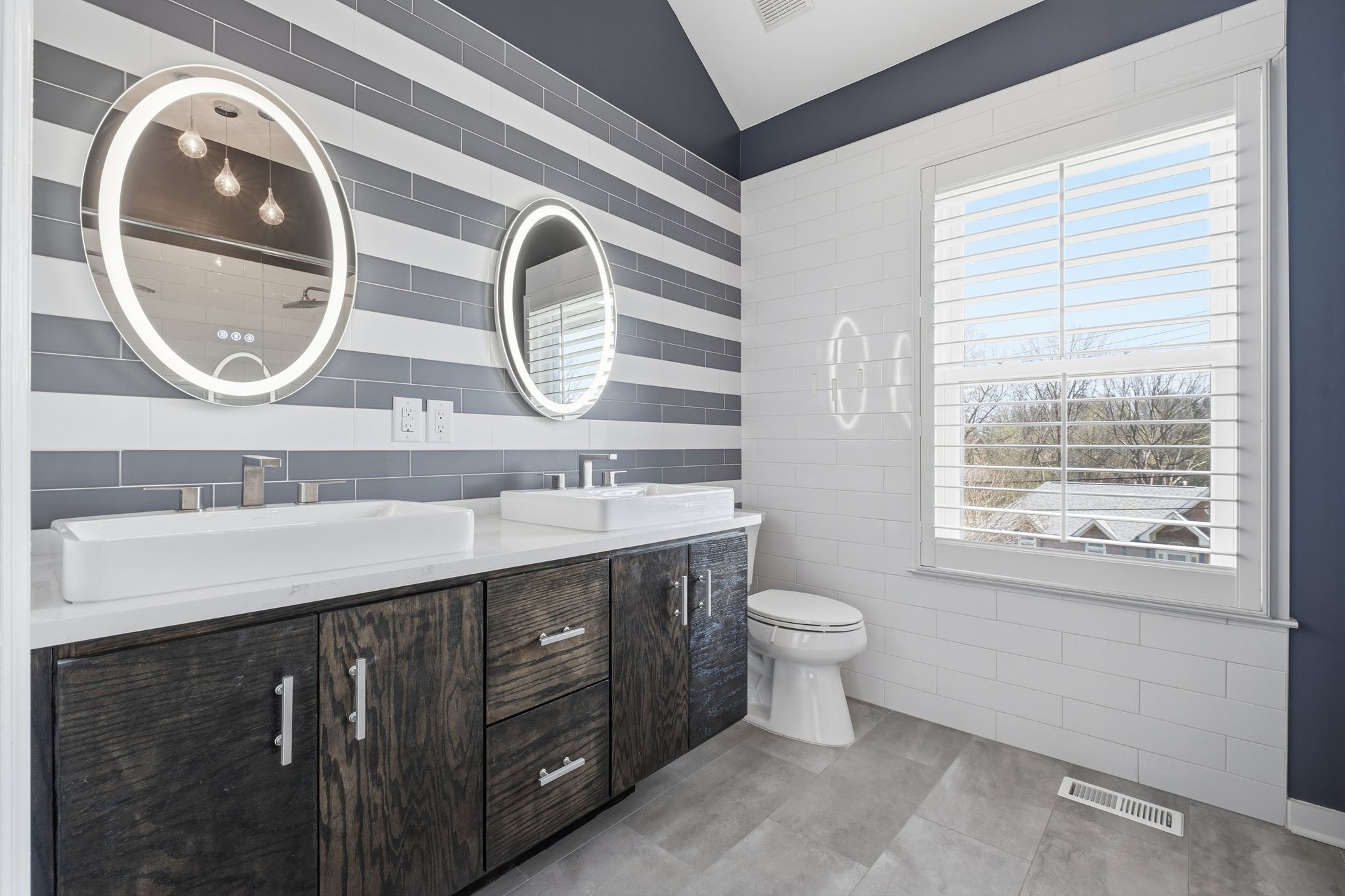 1049 Fitzpatrick Road Nashville, TN 37214 - Photo 15 of 38 a bathroom with a double vanity sink and a mirror
