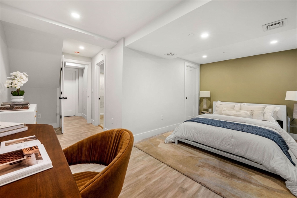 67 Revere Street, Unit 1 Boston, MA 02114 - Photo 11 of 29 a bedroom with bed and a couch