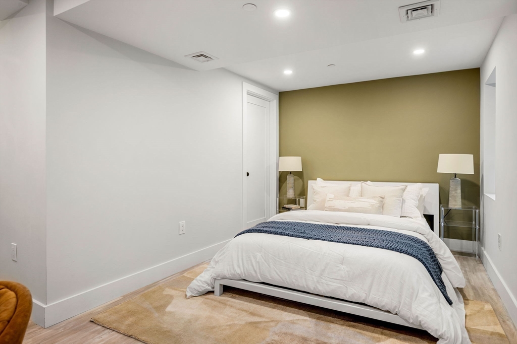 67 Revere Street, Unit 1 Boston, MA 02114 - Photo 12 of 29 a large bed in a room