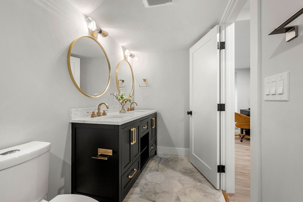 67 Revere Street, Unit 1 Boston, MA 02114 - Photo 14 of 29 a bathroom with a toilet sink and mirror