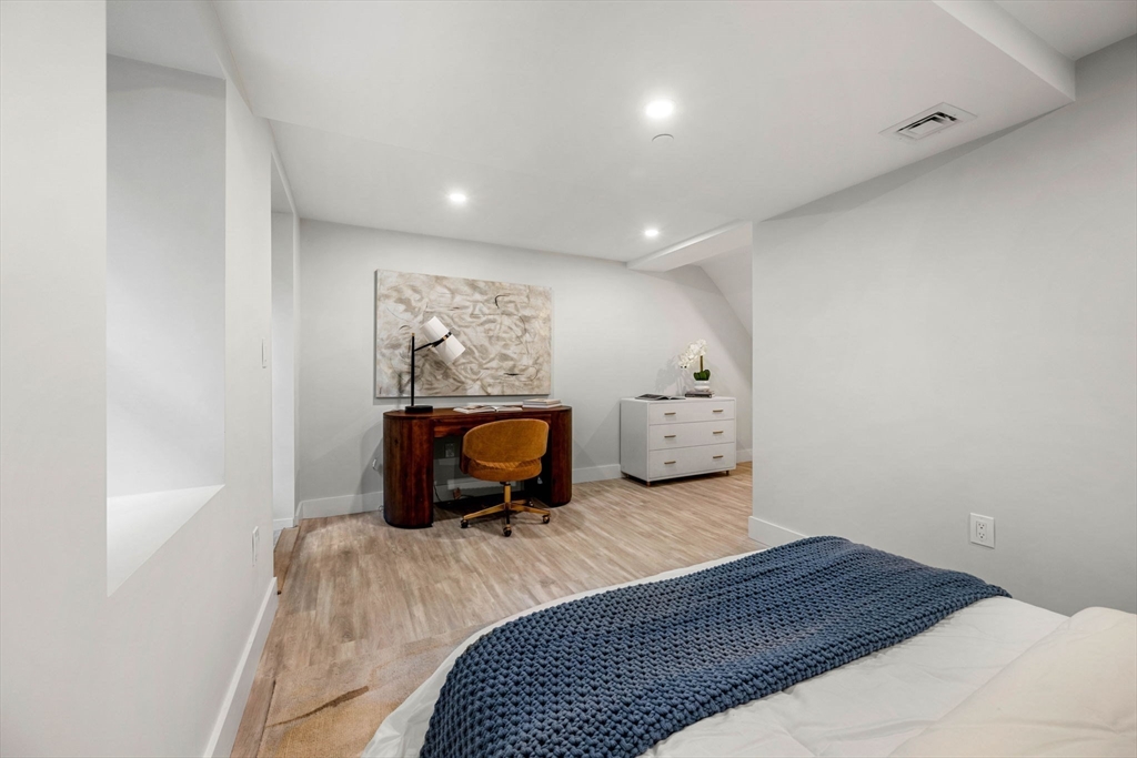 67 Revere Street, Unit 1 Boston, MA 02114 - Photo 16 of 29 a bedroom with a bed and wooden floor
