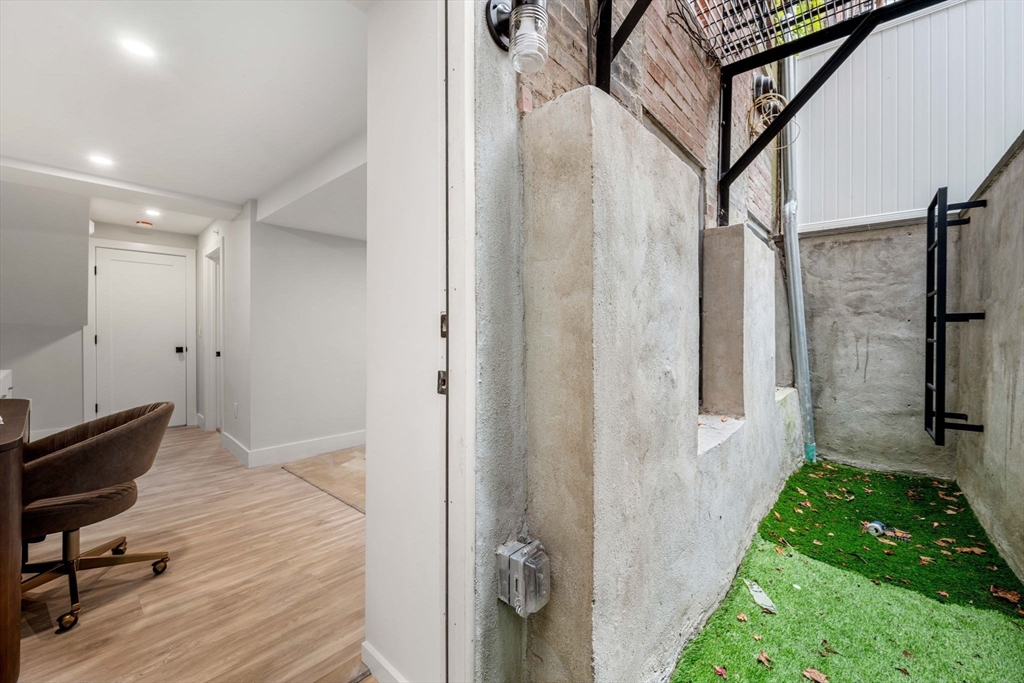 67 Revere Street, Unit 1 Boston, MA 02114 - Photo 17 of 29 a view of a hallway with wooden floor and staircase