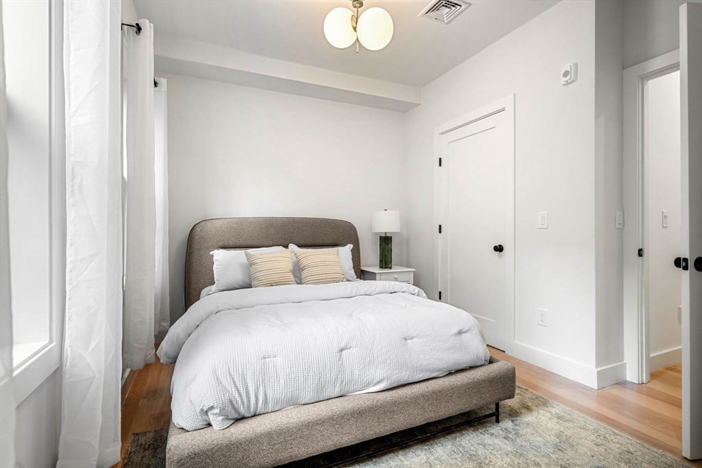 67 Revere Street, Unit 1 Boston, MA 02114 - Photo 24 of 29 a bedroom with a bed and a window
