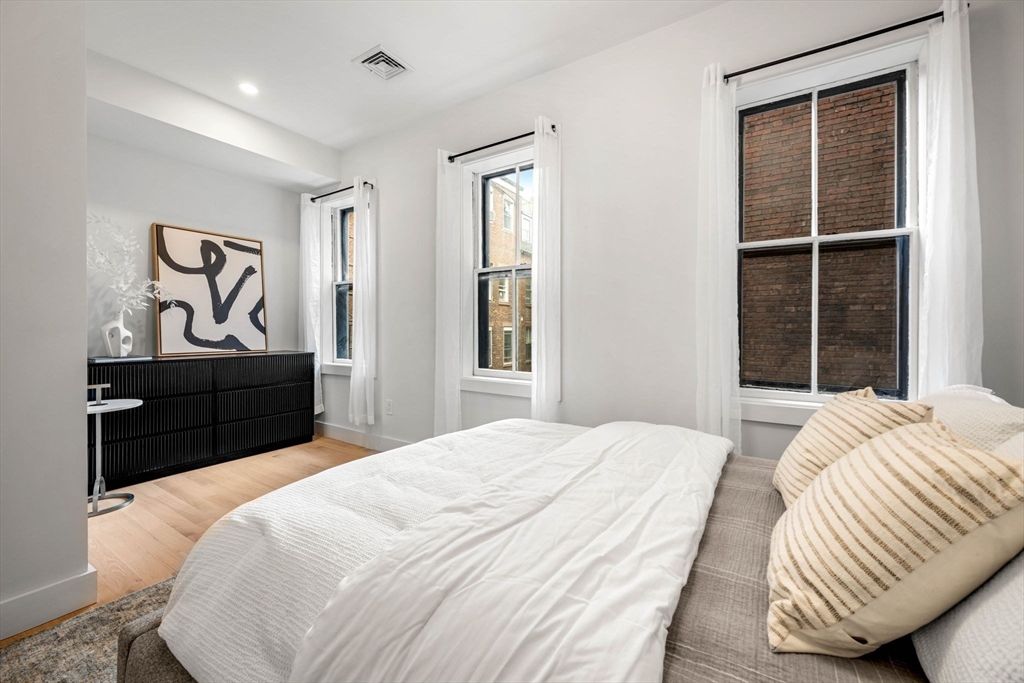67 Revere Street, Unit 1 Boston, MA 02114 - Photo 25 of 29 a bedroom with a bed and a window