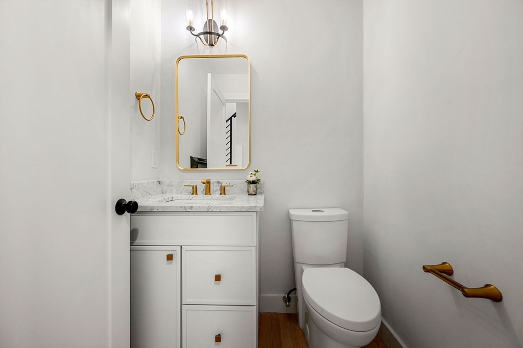 67 Revere Street, Unit 1 Boston, MA 02114 - Photo 27 of 29 a bathroom with a toilet a sink and mirror
