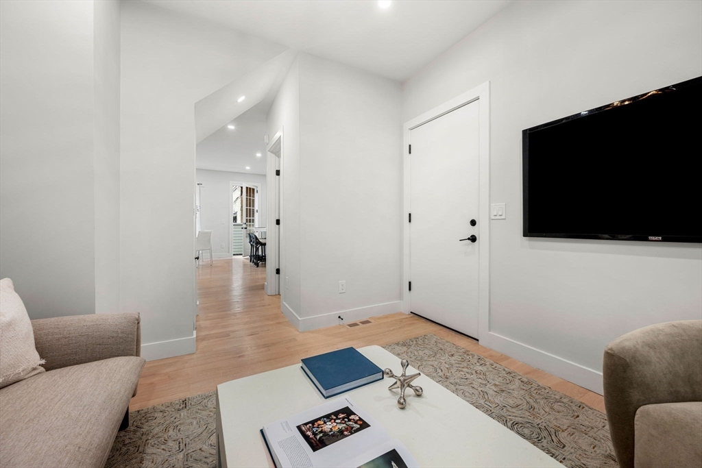 67 Revere Street, Unit 1 Boston, MA 02114 - Photo 28 of 29 a living room with furniture and a flat screen tv