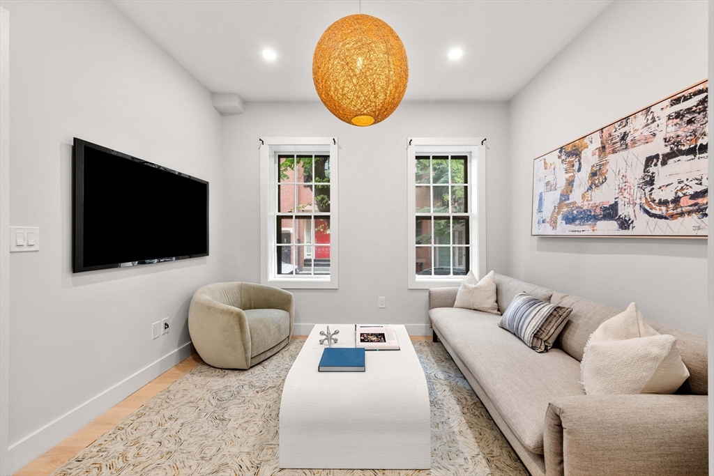 67 Revere Street, Unit 1 Boston, MA 02114 - Photo 8 of 29 a living room with furniture and a flat screen tv