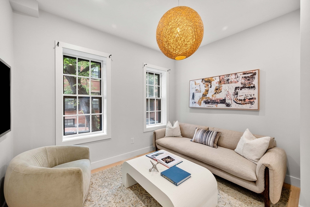 67 Revere Street, Unit 1 Boston, MA 02114 - Photo 9 of 29 a living room with furniture and a window