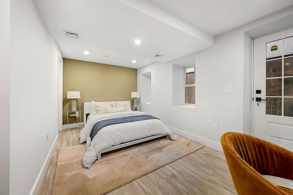 67 Revere Street, Unit 1 Boston, MA 02114 - Photo 10 of 29 a bedroom with a bed and window