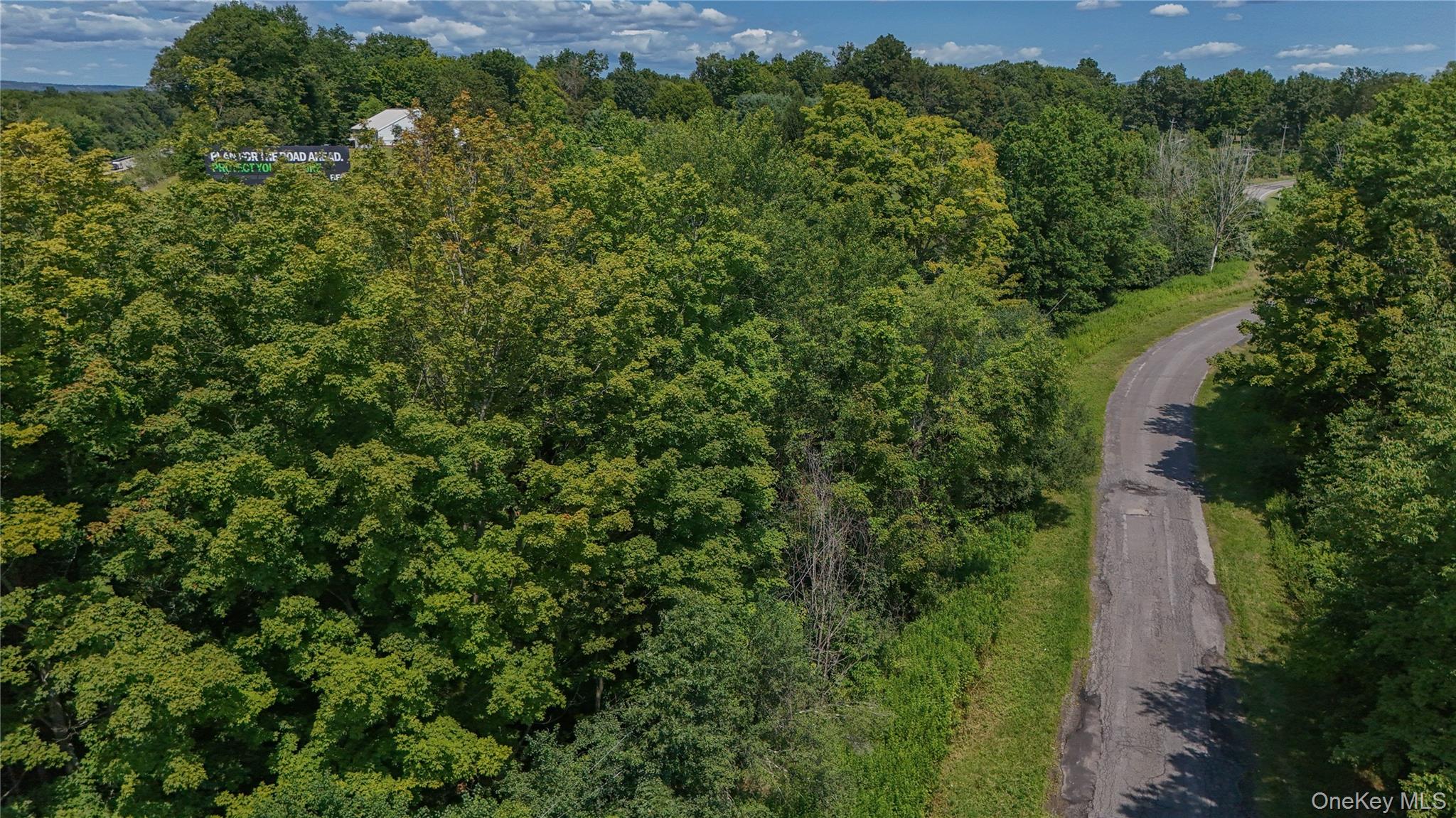 an aerial view of a houses with a yard