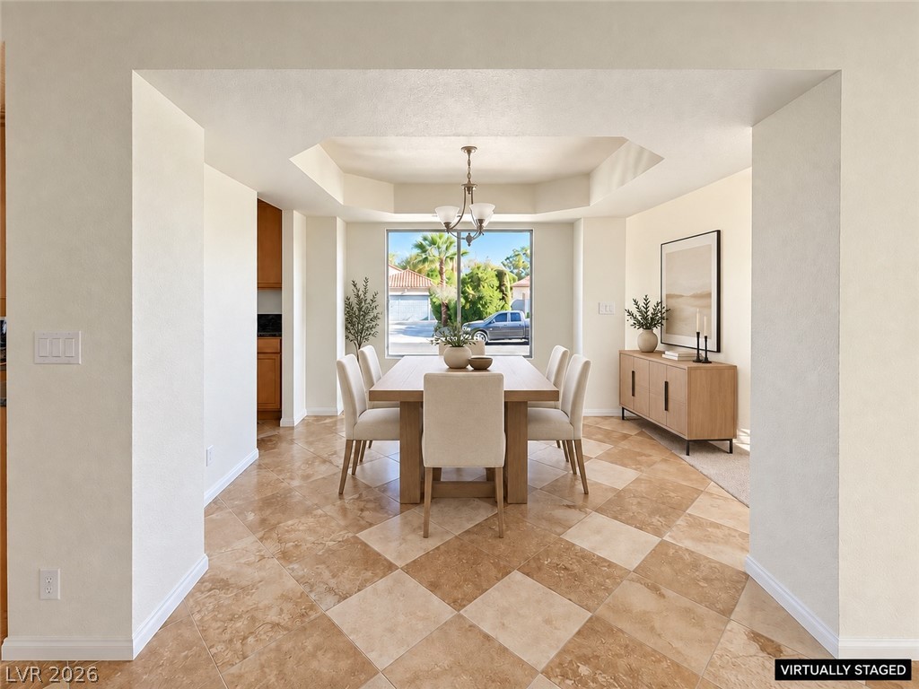 43 Bayridge Road Henderson, NV 89074 - Photo 15 of 47 Gleaming tile floors lead into an elegant dining space featuring a recessed tray ceiling.