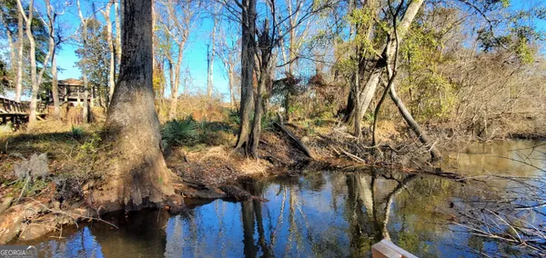a wooden bench sitting next to a lake