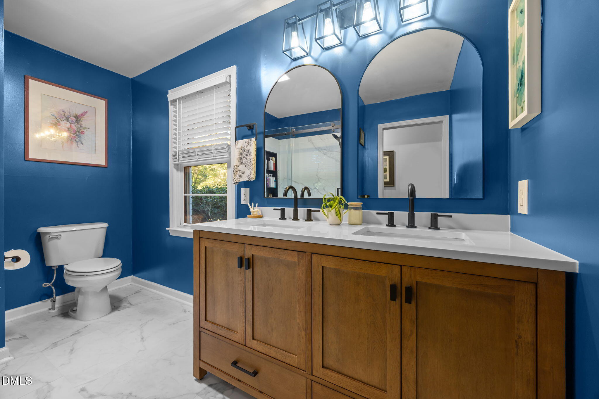 9433 Ferrell Road Zebulon, NC 27597 - Photo 18 of 38 Primary bathroom framed by tranquil hues of blue and white.
