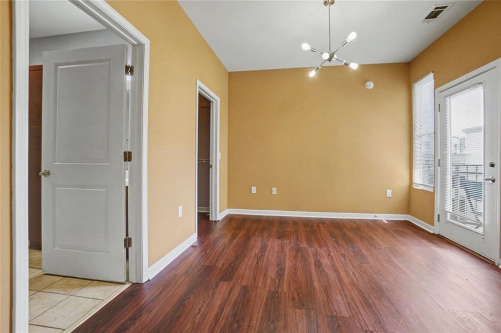 870 Mayson Turner Road Northwest, Unit 1311 Atlanta, GA 30314 - Photo 18 of 29 an empty room with wooden floor and windows