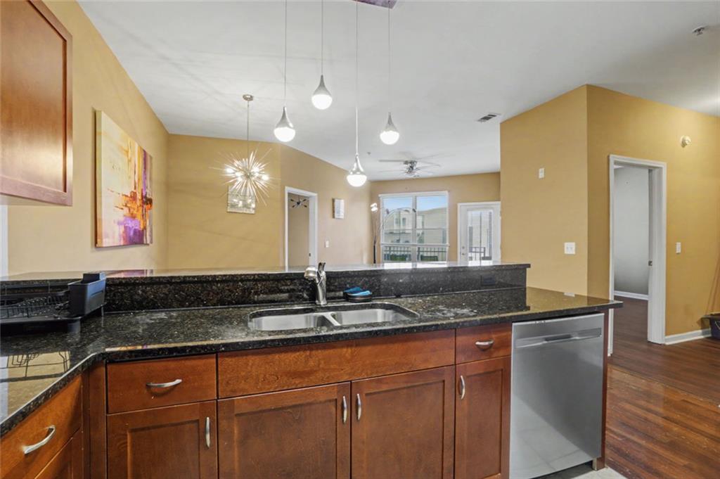 870 Mayson Turner Road Northwest, Unit 1311 Atlanta, GA 30314 - Photo 6 of 29 a bathroom with a granite countertop sink and a mirror