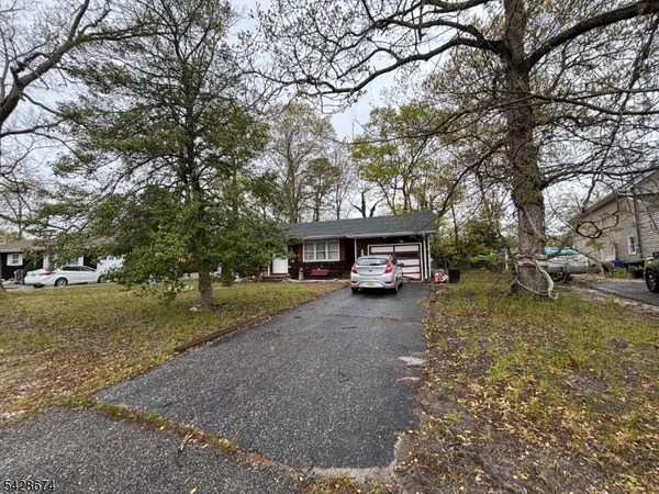 a view of a house with a yard and trees