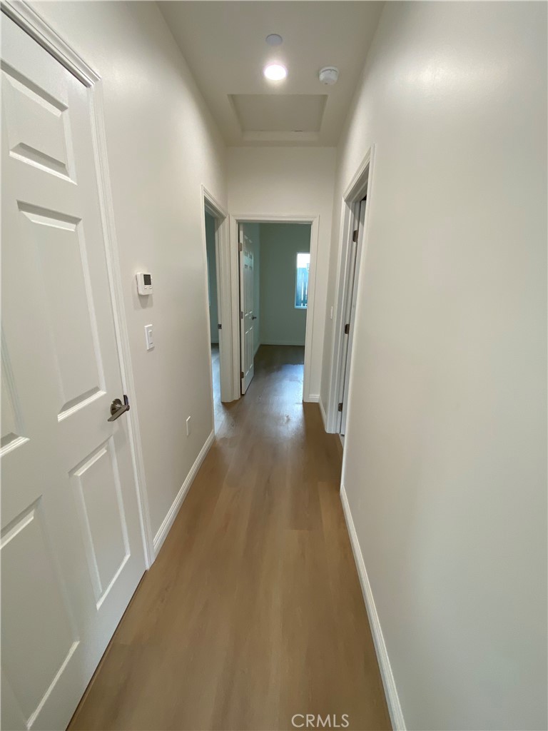 18543 Ingomar Street Reseda, CA 91335 - Photo 5 of 10 a view of a hallway with wooden floor
