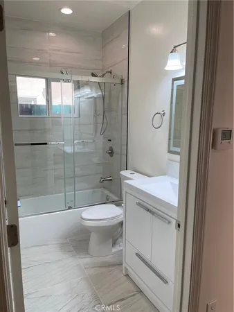 a bathroom with a shower toilet and sink
