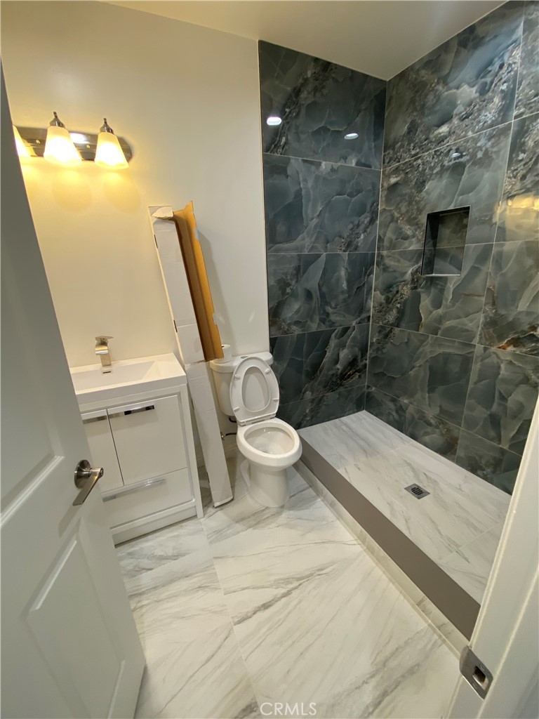 18543 Ingomar Street Reseda, CA 91335 - Photo 10 of 10 a bathroom with a toilet and a shower