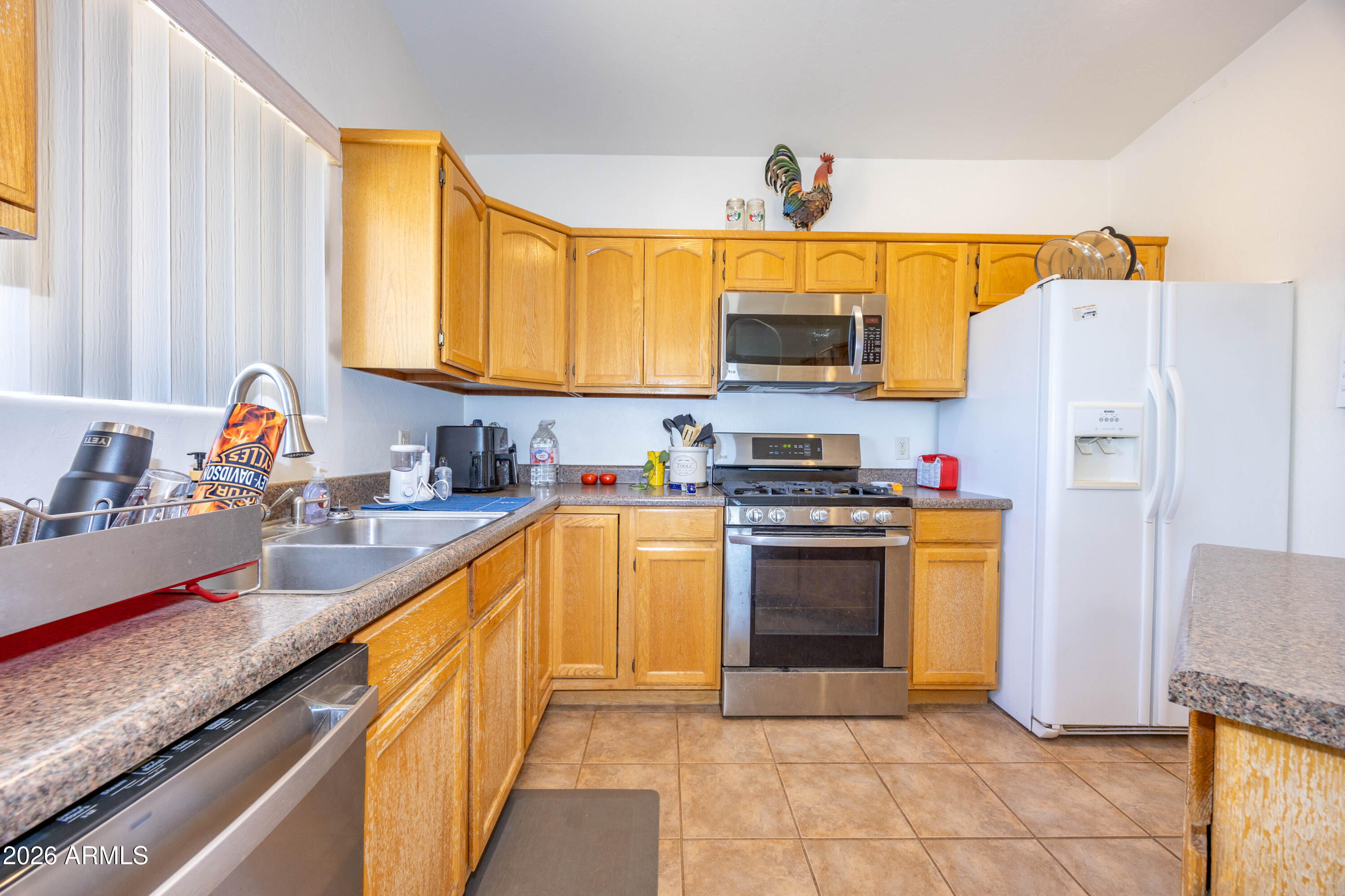 4575 South Kino Road Sierra Vista, AZ 85650 - Photo 17 of 25 a kitchen with granite countertop a sink and a stove top oven
