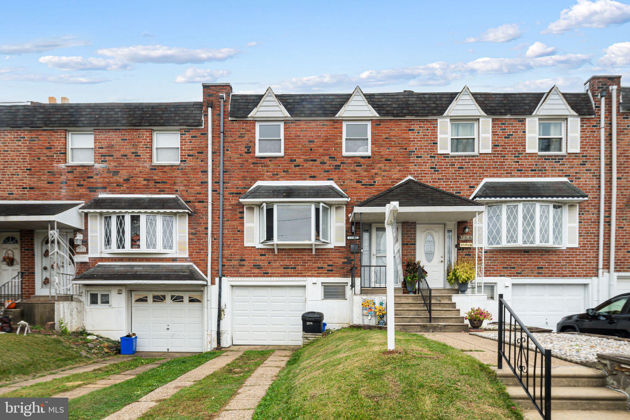 12313 Dunks Ferry Road Philadelphia, PA 19154 - Photo 1 of 29 a front view of a residential apartment building with a yard