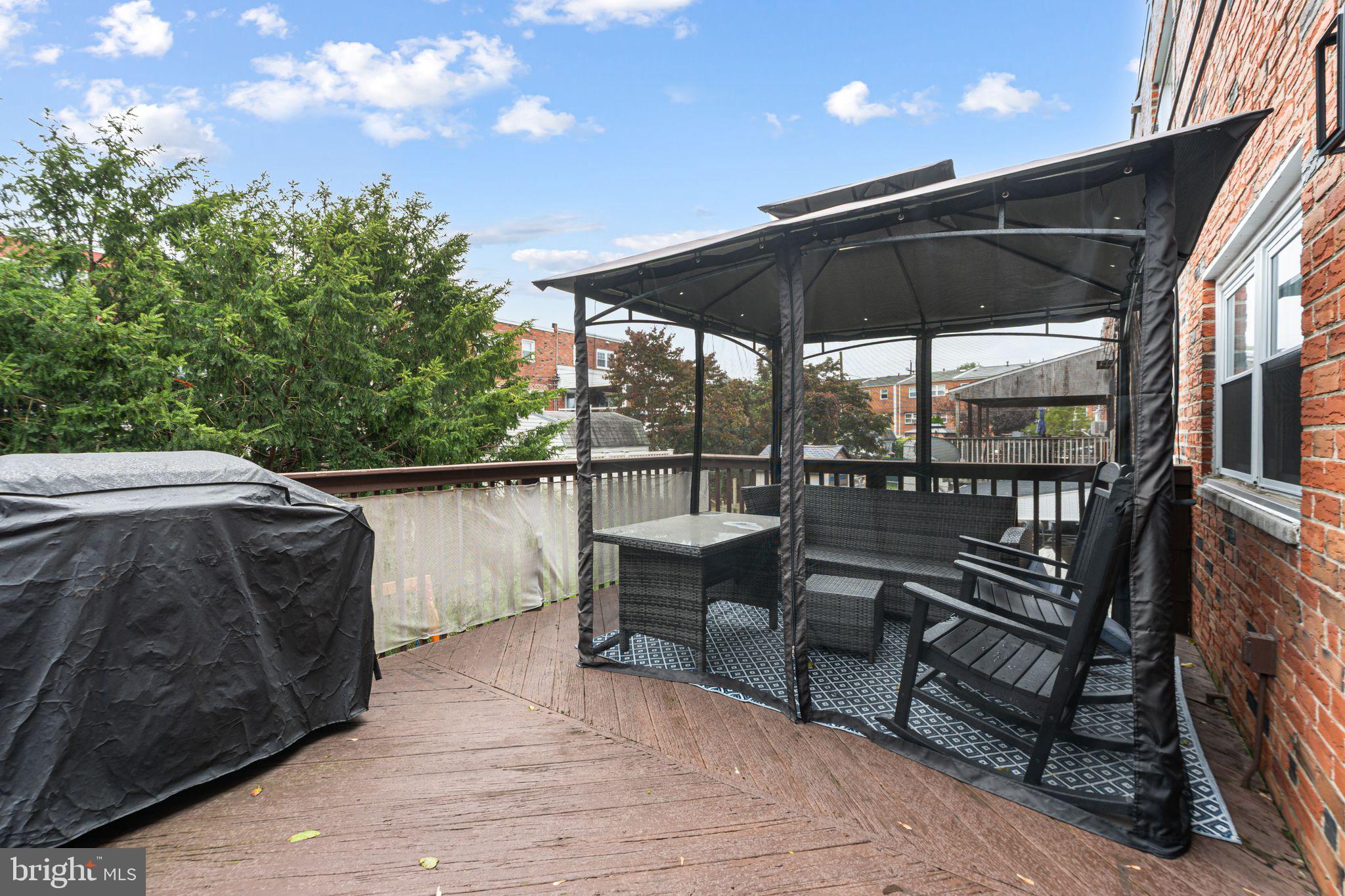 12313 Dunks Ferry Road Philadelphia, PA 19154 - Photo 11 of 29 a roof deck with table and chairs under an umbrella