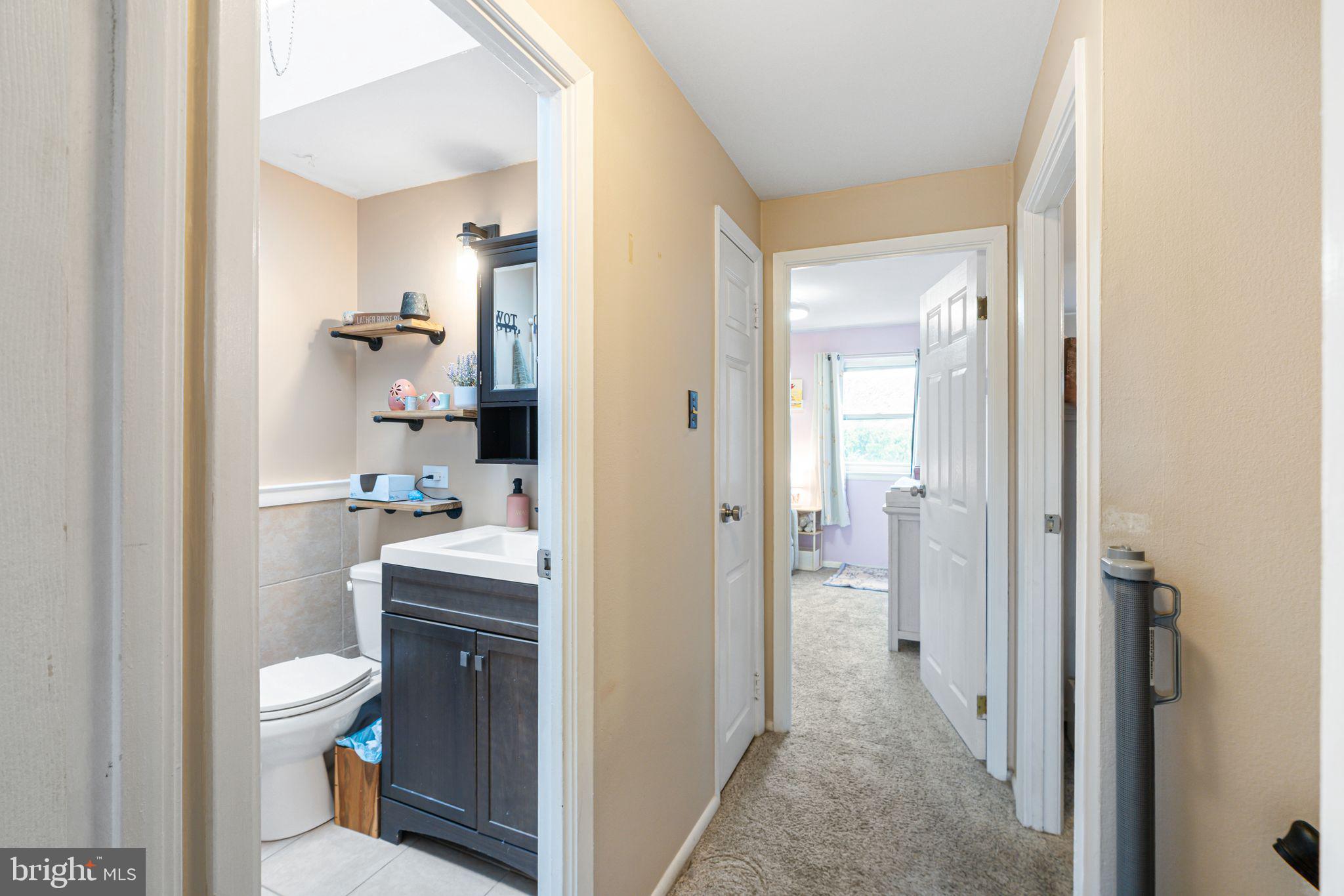 12313 Dunks Ferry Road Philadelphia, PA 19154 - Photo 12 of 29 a bathroom with a toilet a sink and a mirror