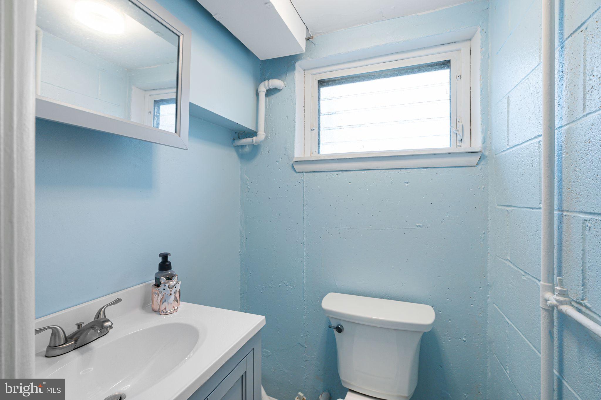 12313 Dunks Ferry Road Philadelphia, PA 19154 - Photo 26 of 29 a bathroom with a sink a toilet and a mirror