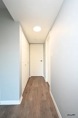 a view of a hallway with wooden floor