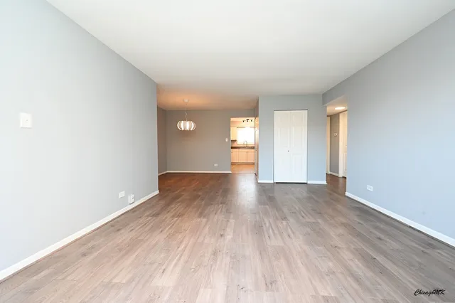 a view of an empty room and wooden floor