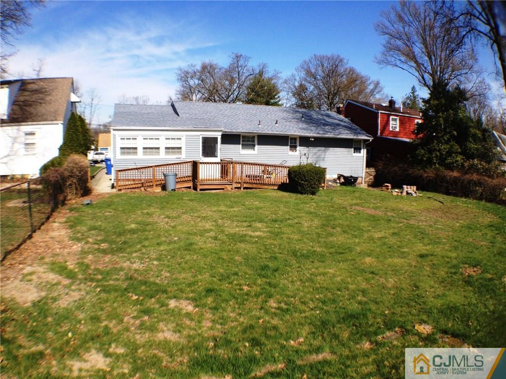 75 East Cliff Road Colonia, NJ 07067 - Photo 2 of 3 a view of a house with a big yard and large trees