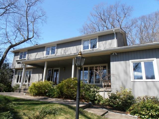9 Maple Ridge Road Trumbull, CT 06611 - Photo 1 of 1 a view of a building with a yard large trees and plants