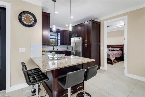 a view of a dining room with furniture and a kitchen