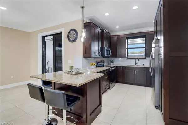 a kitchen with a sink cabinets and window