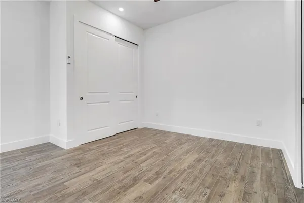 a view of an empty room with wooden floor