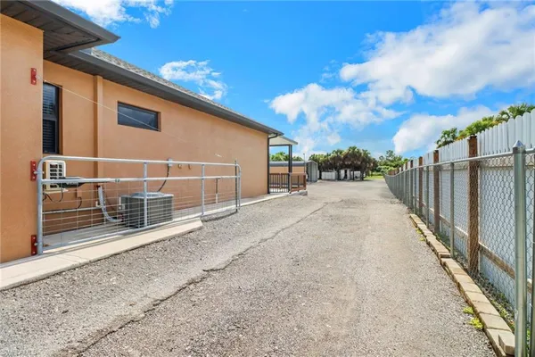 a view of a house with wooden fence