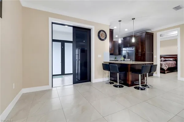 a view of kitchen with a sink and a refrigerator