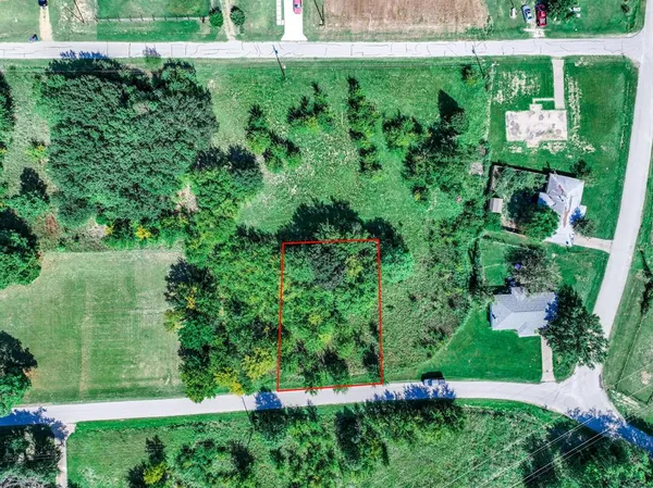 an aerial view of residential house with outdoor space and trees all around