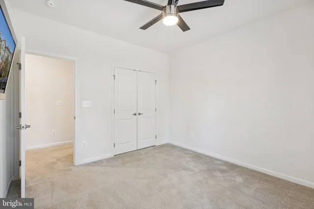 a view of a room with a ceiling fan