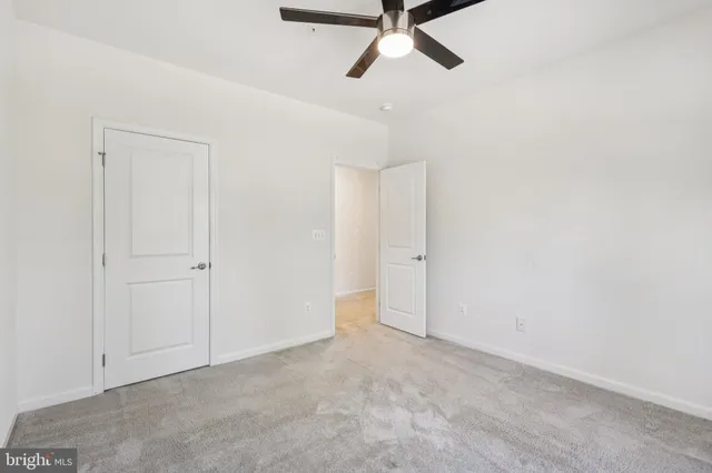 a view of a room with a ceiling fan