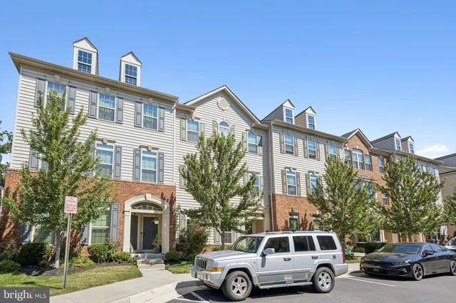 a front view of a residential apartment building with a yard