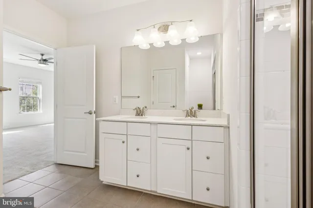 a bathroom with a double vanity sink mirror and