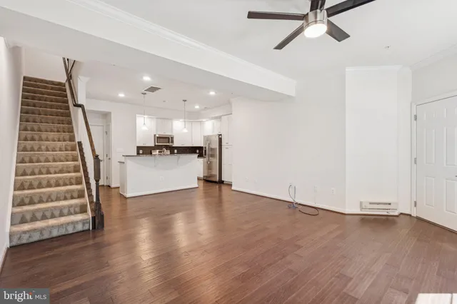 a view of a kitchen with wooden floor and stairs