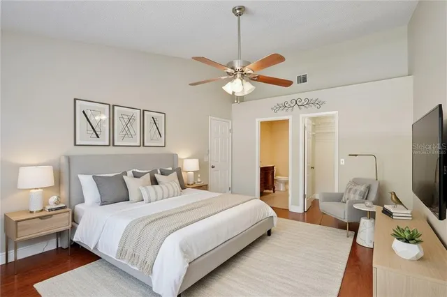 a bedroom with a large bed and a chandelier