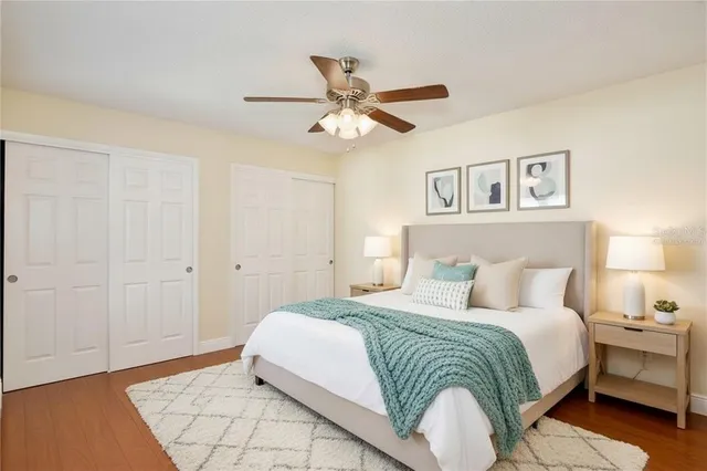 a bedroom with a bed and a ceiling fan