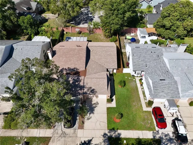 an aerial view of a house with a yard