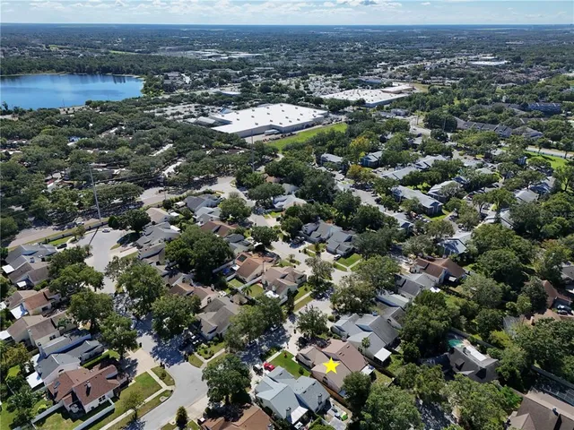 an aerial view of residential houses with outdoor space and swimming pool