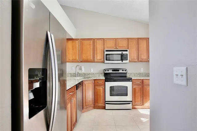 a kitchen with a refrigerator stove and microwave