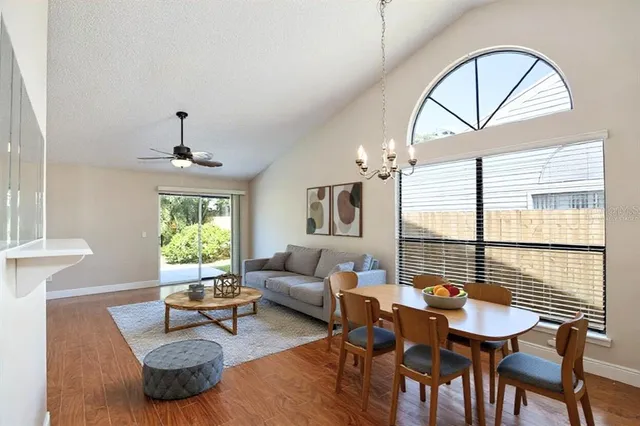 a living room with furniture a window and a chandelier