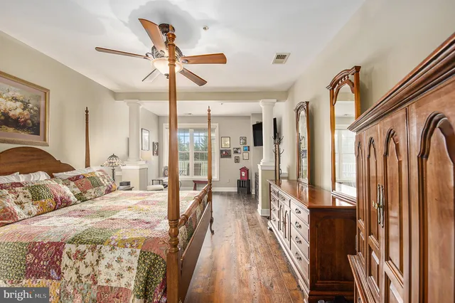 a bedroom with a large bed and a chandelier